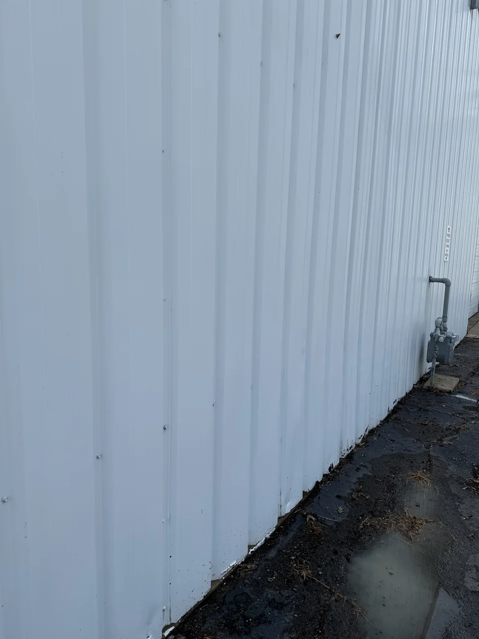 Metal siding on a commercial building after cleaning by River City Pressure Washing
