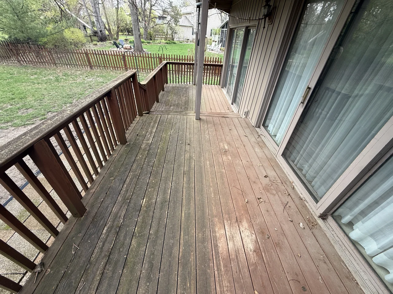 Covered wood deck before restoration by River City Pressure Washing