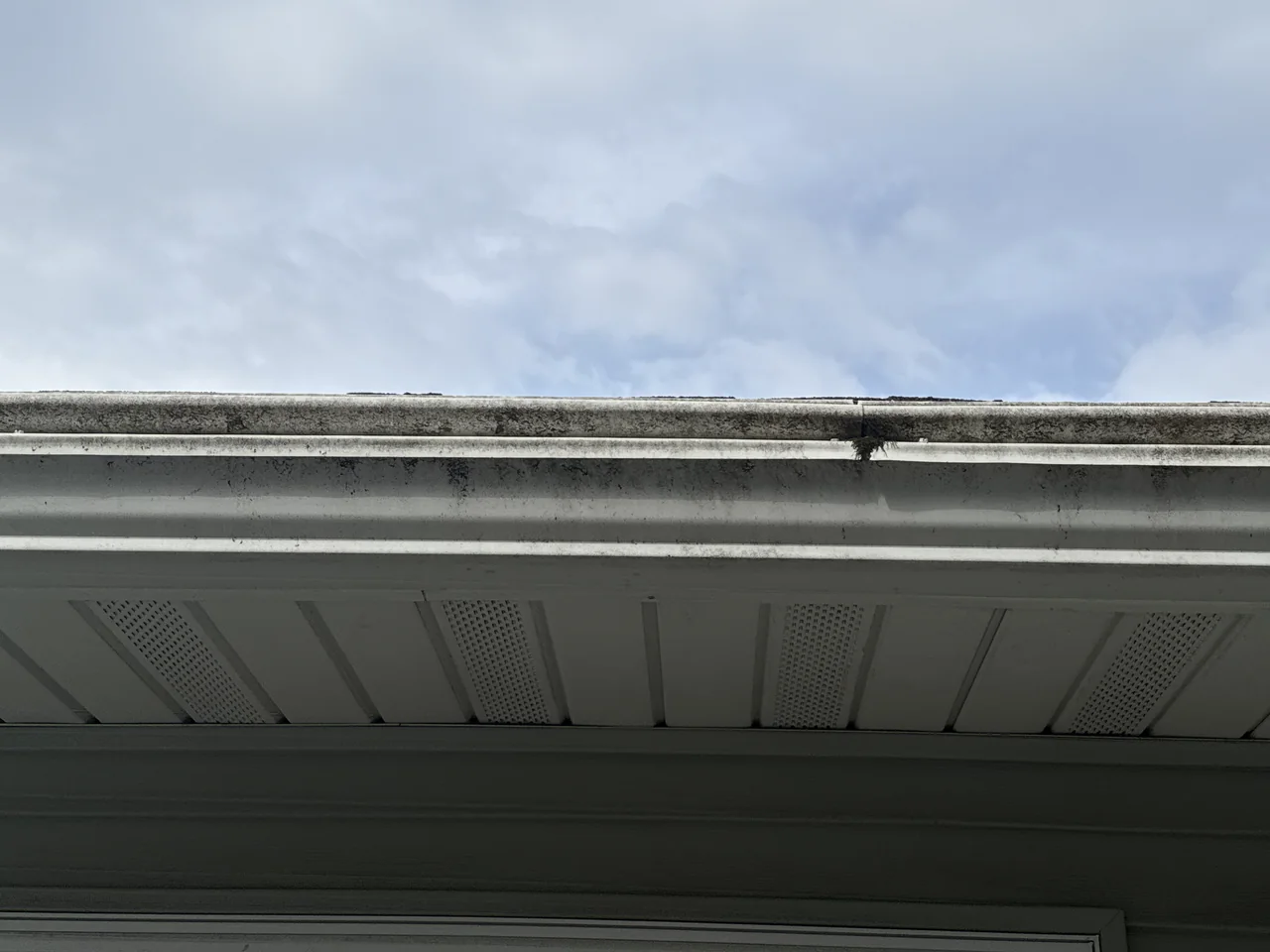 White gutter exterior and soffit before cleaning by River City Pressure Washing