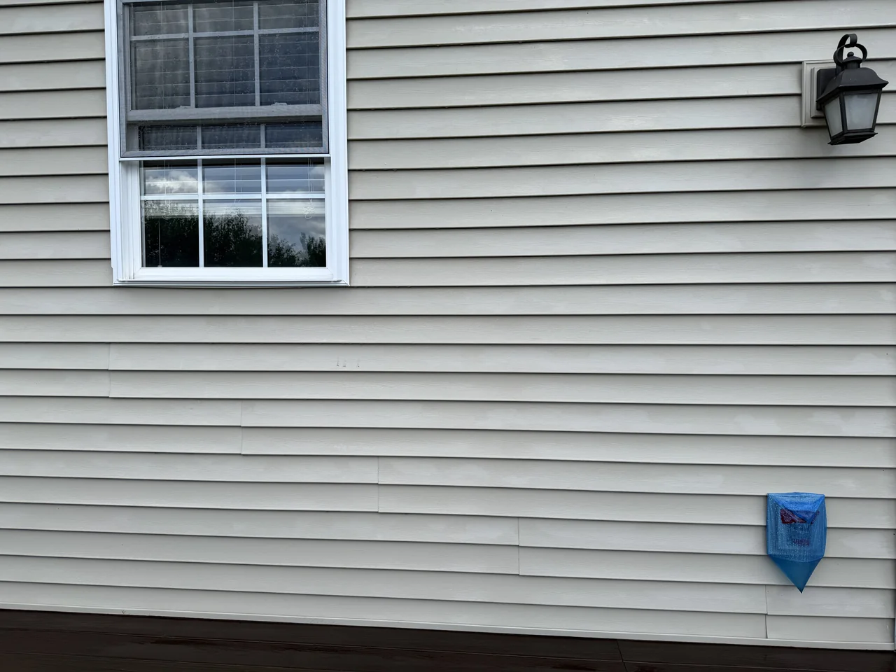 Vinyl siding around a window after cleaning by River City Pressure Washing