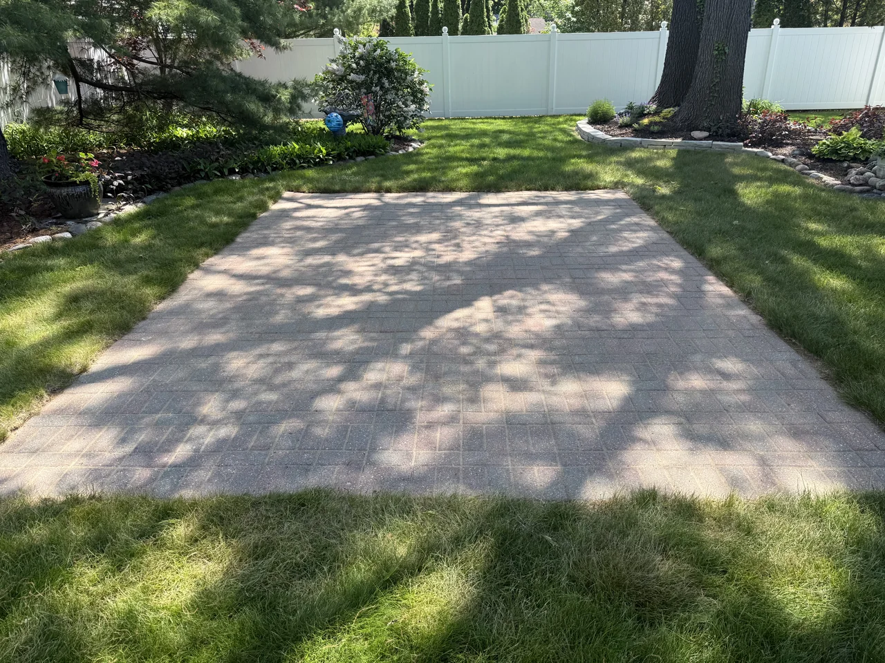 Backyard paver patio after cleaning by River City Pressure Washing