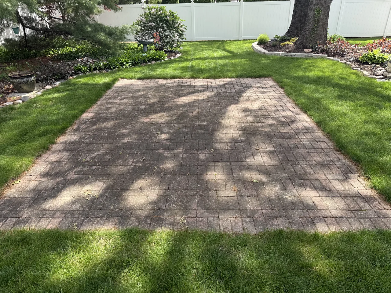 Backyard paver patio before cleaning by River City Pressure Washing