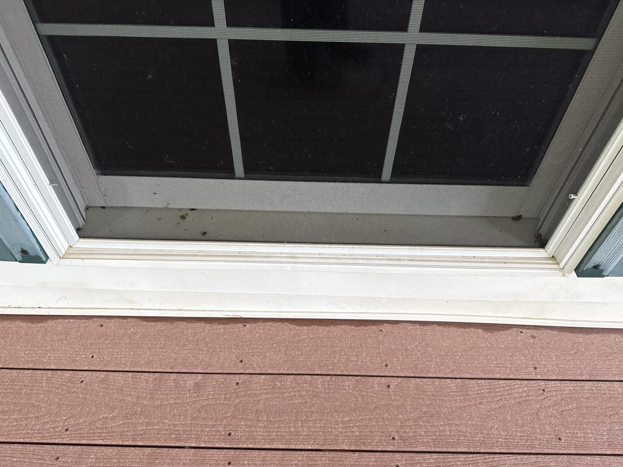 Lower screen-door frame and sill after cleaning by River City Pressure Washing